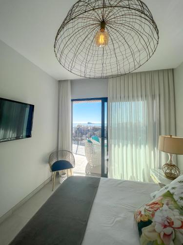 a bedroom with a large bed and a large window at Sunset Waves 3 Benidorm in Benidorm