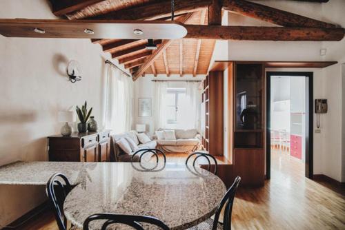 Zimmer mit einem Tisch und Stühlen sowie einem Wohnzimmer in der Unterkunft La Corte di Costantino-Downtown Como in Como