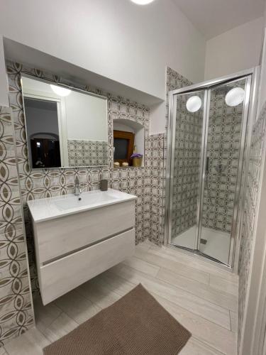 a bathroom with a sink and a shower at Arcaroli Borgo Vico "La casetta" in Vico del Gargano