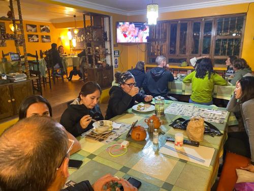 a group of people sitting at a table eating at La Casa de Zarela in Huaraz