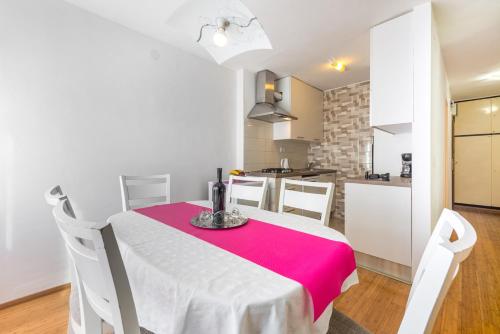 a kitchen and a table with a red and white table cloth at Apartment Lidija in Dubrovnik