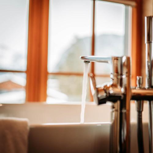 a stream of water coming out of a faucet at IM WEIDACH Superior Chalets in Leutasch