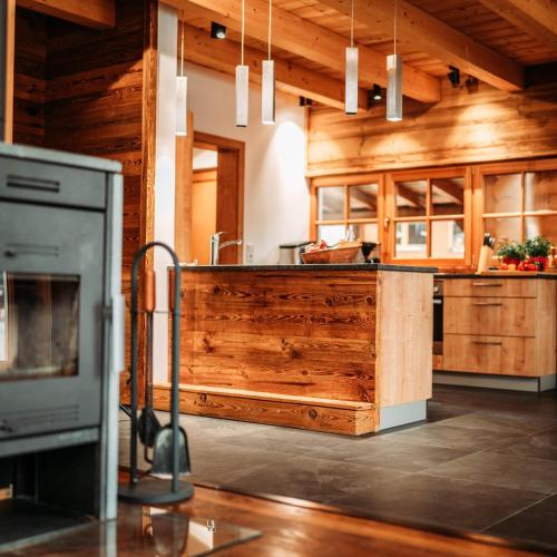 a kitchen with wooden cabinets and a counter top at IM WEIDACH Superior Chalets in Leutasch