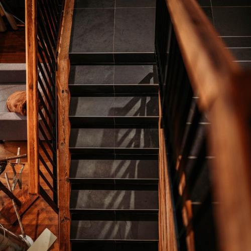 an overhead view of a wooden spiral staircase at IM WEIDACH Superior Chalets in Leutasch