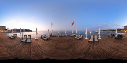 a group of tables and chairs on the beach at Anitas Hotel in Konaklı