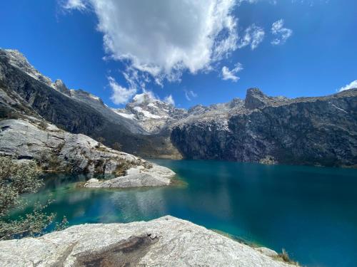 a view of a blue lake in the mountains at La Casa de Zarela in Huaraz