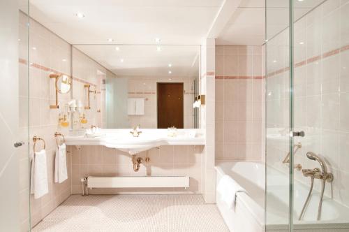 a bathroom with a sink and a shower at Maritim Hotel Magdeburg in Magdeburg