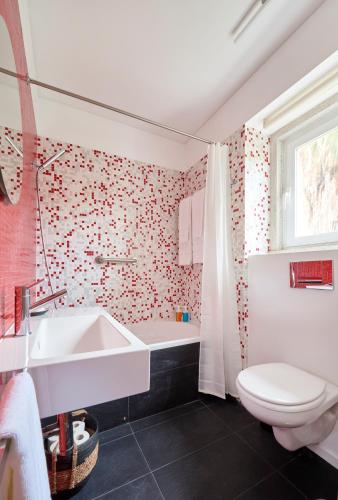a bathroom with a white sink and a toilet at Sunny Renovated Apt With AC, By TimeCooler in Lisbon