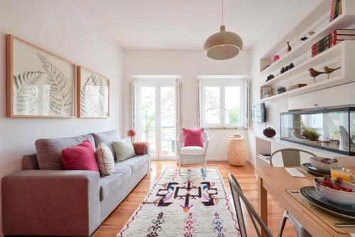 a living room with a couch and a fish tank at Sunny Renovated Apt With AC, By TimeCooler in Lisbon