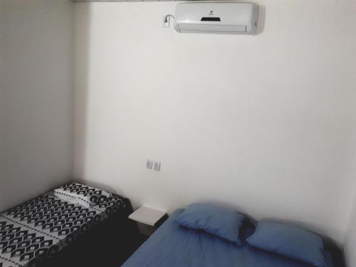 a small bedroom with two beds and a heater at POUSADA DO BETO in Atins