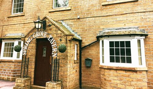 an entrance to a brick building with a sign on it at Spring Grove B&B in Huddersfield