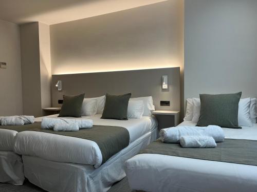 a bedroom with two beds with pillows on them at VTZ Hotel San Valero in Zaragoza