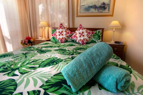 a bedroom with a green and white bed with pillows at TryOver in Meningie