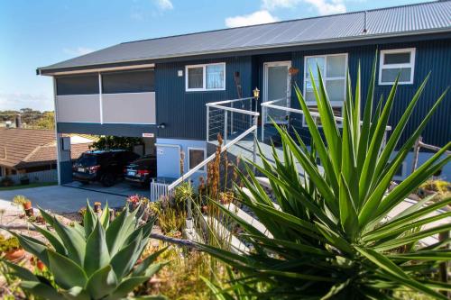 a blue house with a car parked in front of it at TryOver in Meningie