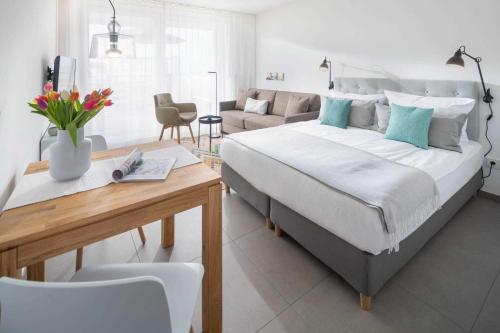 a bedroom with a large bed and a living room at WestStrandBlick in Norderney