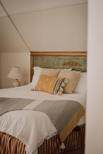 a bedroom with a large bed with pillows on it at Hill Road Manor Bed & Breakfast in Grand Falls