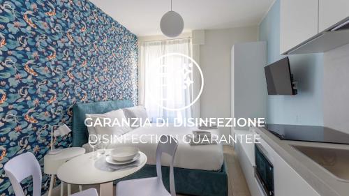 a kitchen with a table and chairs in a room at Italianway - The B Village Business in Milan
