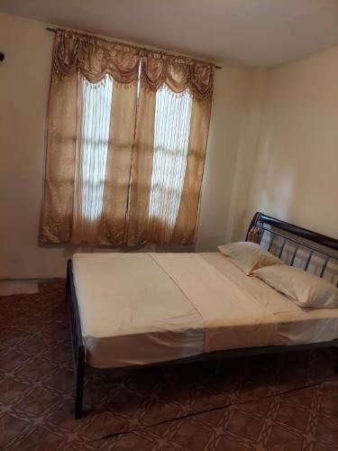 a bedroom with a large bed with a window at CASTLE VIEW VILLA in Diamond