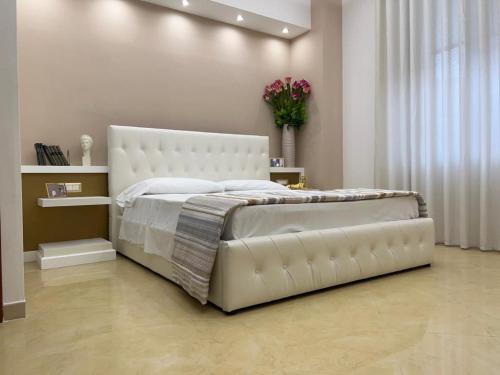 a bedroom with a large white bed in a room at Pompei Royal Suite in Pompei