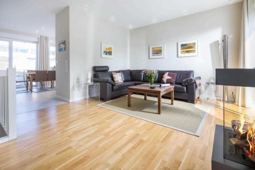 a living room with a couch and a table at Robbenloft in Norderney