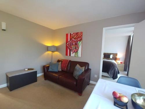 a living room with a couch and a bed at Portreeves in Arundel