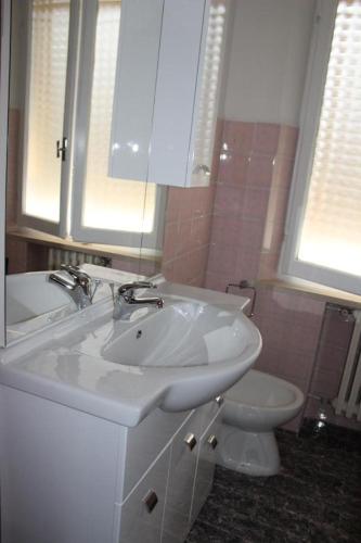 a bathroom with a white sink and a toilet at La casa al mare in Marcelli