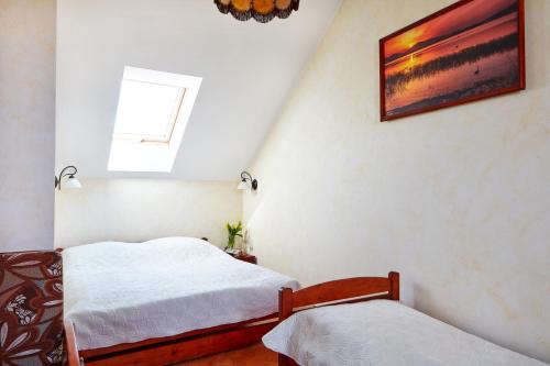 Postel nebo postele na pokoji v ubytování Ośrodek Wypoczynkowy Nad Jeziorem