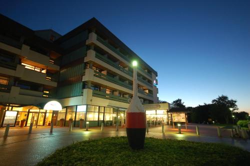 a large building with a street light in front of it at Aquantis Bensersiel in Bensersiel