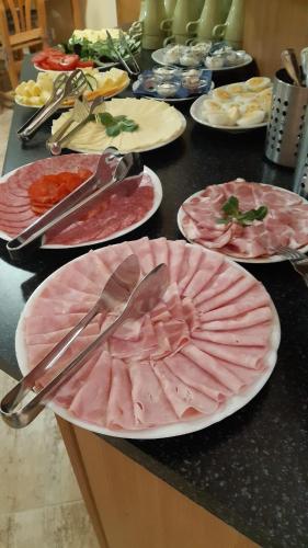 a table with many plates of food on it at PENSION ANNA in Špindlerův Mlýn
