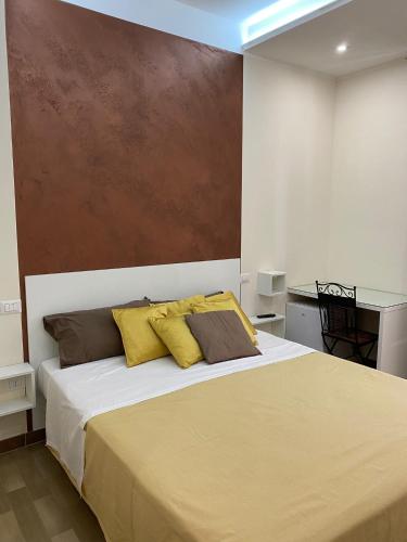 a bedroom with a large bed with yellow pillows at room milo in Gallipoli