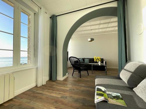 a living room with a couch and a table at Douceur Marine in Cancale