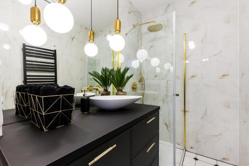 a bathroom with a sink and a mirror at LuxApart Gdańsk in Gdańsk