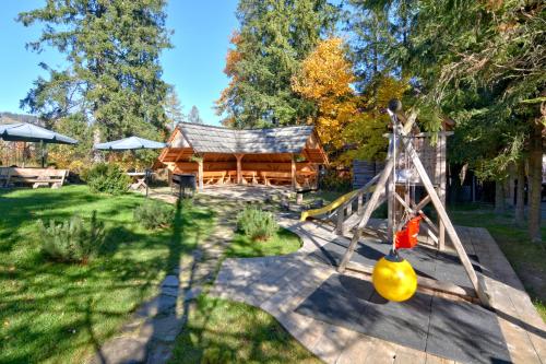 a swing set in a yard with a log cabin at Tatra House Residence in Zakopane