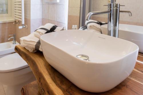 a bathroom with a white sink on a wooden counter at Chez Monti in Rome