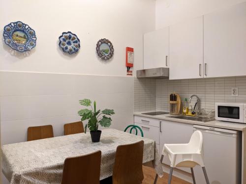 a kitchen with a table and plates on the wall at BOA LISBOA 3 bedroom spacious apartment in Lisbon
