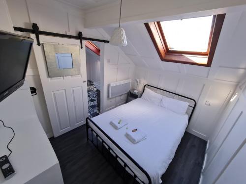 a small bedroom with a bed and a window at Elmora House in Blackpool