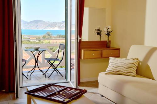 a living room with a couch and a balcony at Villa Reverenza in Lixouri