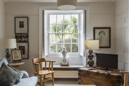 a living room with a window and a tv at Antonia's Pearls in St Austell