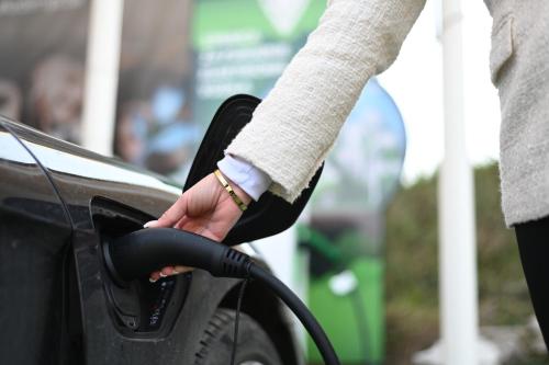 a person is filling a car with gasoline at Hotel Vertigos in Tuzla