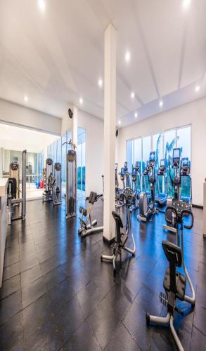 a gym with several treadmills and cardio machines at Dreams Karibana Cartagena Golf & Spa Resort in Cartagena de Indias