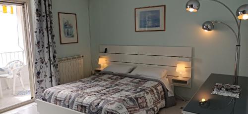a bedroom with a bed and a table with two lamps at Turchese in Amalfi