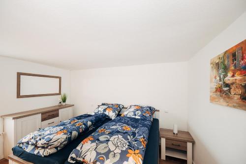 a bed with a blue comforter in a room at Ferienwohnung am Lindbruch in Niederkrüchten