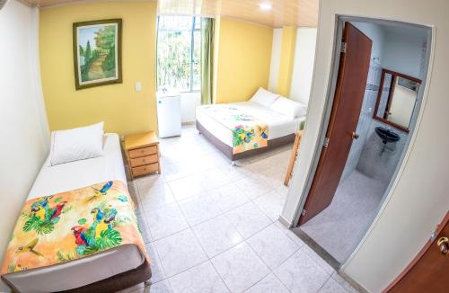 a small room with two beds and a mirror at Centro Recreacional IASCEBOY in Barbosa