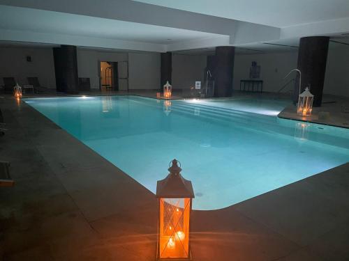 a large swimming pool with a candle in front of it at Grand Hotel Villa Itria Congress & Spa in Viagrande