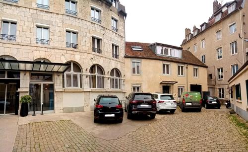 a group of cars parked on a street next to buildings at Best Western Citadelle in Besançon
