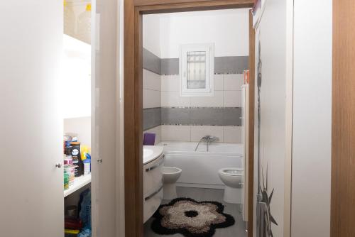 a bathroom with a tub and a toilet and a sink at VILLA PATERTE in Marina di Mancaversa