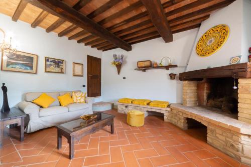 a living room with a couch and a fireplace at Torre di Polvereto in Montespertoli
