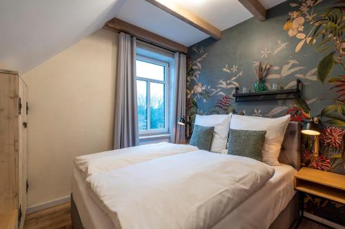 ein Schlafzimmer mit einem großen weißen Bett in einem Zimmer in der Unterkunft Verwalter Haus Apartment 2 in Bad Segeberg