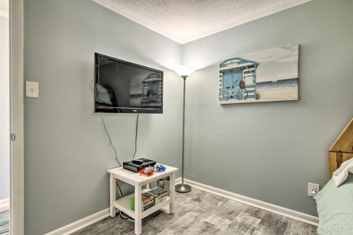 a room with a flat screen tv on a wall at Walk to Ocean City Boardwalk Waterfront Condo in Ocean City
