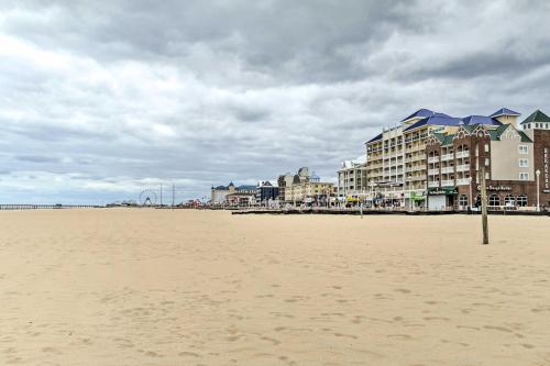 a sandy beach with buildings and condos on a cloudy day at Walk to Ocean City Boardwalk Waterfront Condo in Ocean City
